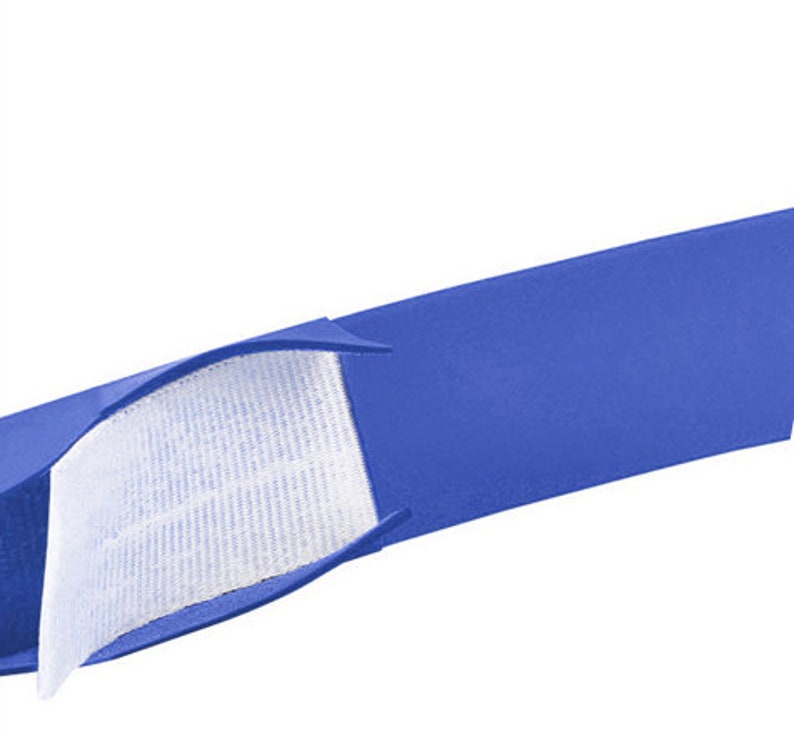May include: A blue fabric strap with a white hook and loop fastener. The strap is folded in half, showing the inside of the fastener.