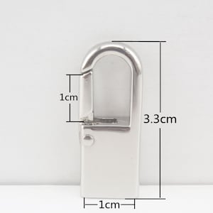 May include: Silver metal clasp with a spring-loaded gate. The clasp measures 1 inch wide and 3.3 inches long.