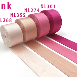 May include: Four rolls of pink nylon webbing tape arranged in a row, labeled with codes NL268, NL355, NL274, and NL301. The colors transition from a pale blush pink to a deep magenta, each featuring a distinct diagonal herringbone weave texture.