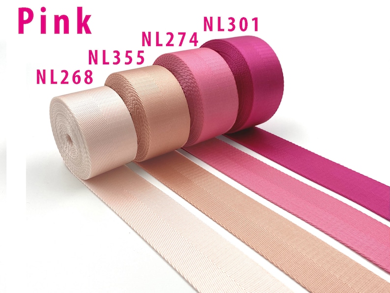May include: Four rolls of pink nylon webbing tape arranged in a row, labeled with codes NL268, NL355, NL274, and NL301. The colors transition from a pale blush pink to a deep magenta, each featuring a distinct diagonal herringbone weave texture.