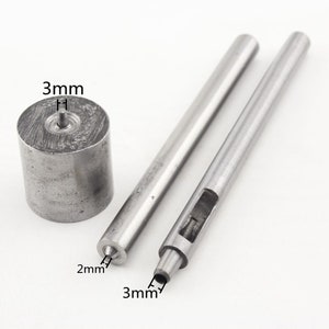 May include: A set of three metal tools for leather crafting. The tools include a 3 mm punch, a 2 mm punch, and a 3 mm hollow punch.