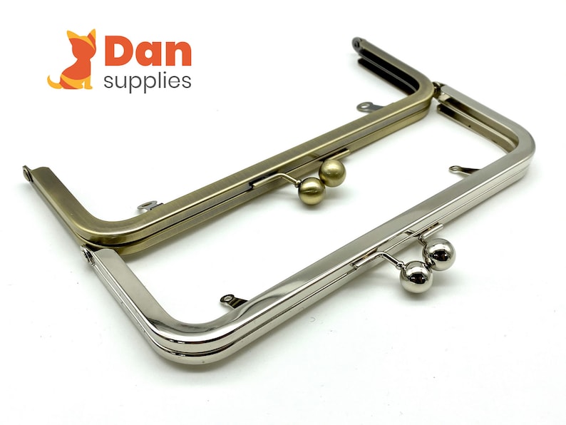 May include: Two purse frames, one silver and one gold, with two round metal clasps on each.