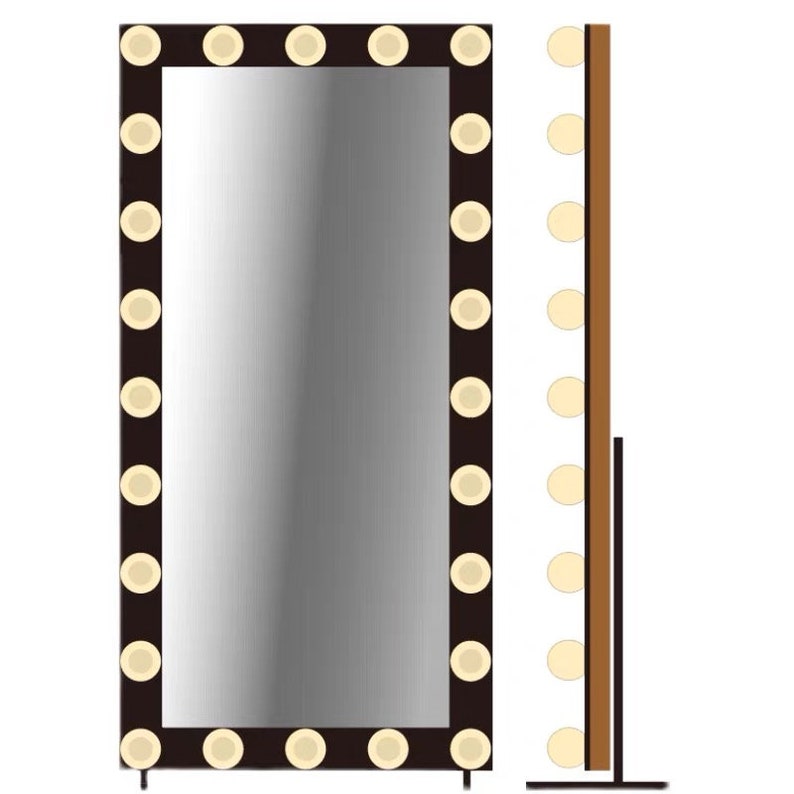 May include: A full-length mirror with a black frame and a row of round, white lights around the perimeter. The mirror is standing on a black stand.
