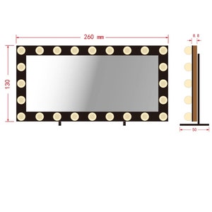 May include: A black vanity mirror with a white frame and 18 light bulbs around the perimeter. The mirror is 260 mm wide and 130 mm tall. The mirror is on a stand with two legs.