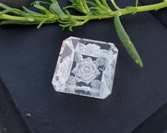 May include: A clear glass cube with a white rose and leaves etched into the surface.