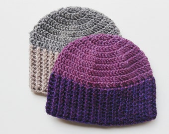 May include: Two crocheted hats, one gray and one purple with a darker purple band.