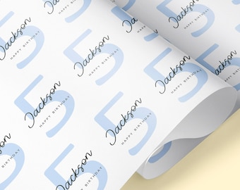May include: White wrapping paper with a repeating pattern of light blue circles containing the number "5" and the name "Jackson" with the text "Happy Birthday".