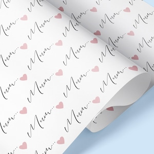 May include: White wrapping paper with a repeating pattern of pink hearts and the word "Mum" written in black cursive.