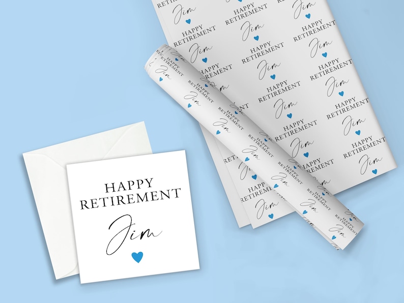 May include: A white card with blue text that reads "Happy Retirement Jim" with a small blue heart. The card is on a light blue background with a roll of white wrapping paper with a repeating pattern of blue hearts and the text "Happy Retirement Jim".