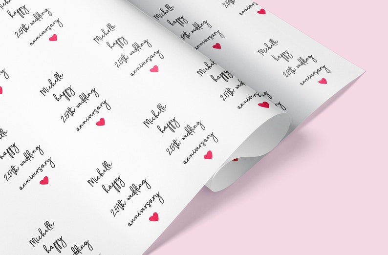 May include: White wrapping paper with a repeating pattern of red hearts and the text "Michelle happy 25th wedding anniversary".