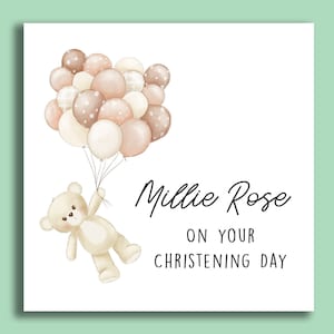 K&ouml;nnte beinhalten: Eine wei&szlig;e Karte mit einem Teddyb&auml;r, der braune und cremefarbene Ballons h&auml;lt. Die Karte lautet "Millie Rose zu deinem Tauftag".