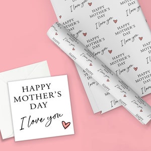 May include: White gift wrap with a repeating pattern of "Happy Mother's Day I love you" with a pink heart. A white card with the same text is on a pink background.
