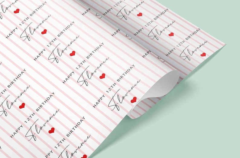 May include: Pink and white striped wrapping paper with the text "Happy 12th Birthday Florence" repeated in a pattern. Red hearts are scattered throughout the design.
