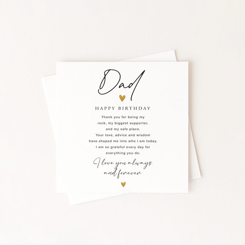 May include: A white greeting card with the word "Dad" in elegant script, a gold heart, and the words "Happy Birthday." The card includes a heartfelt message expressing gratitude and love. The card is on a white background.