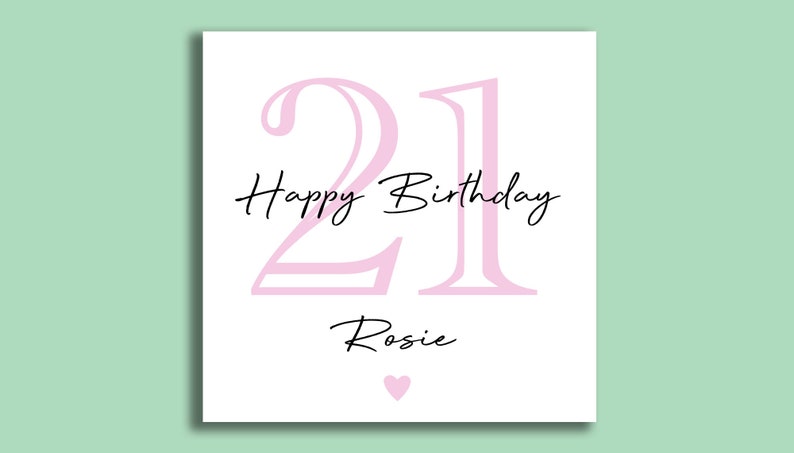 May include: A white birthday card with a light pink "21" and the words "Happy Birthday Rosie" in black script. A small pink heart is at the bottom. The card is on a light green background.