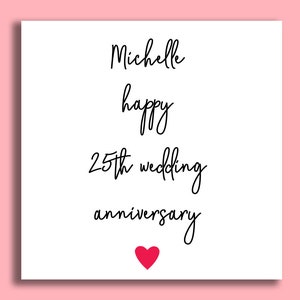 May include: A white card with black text that reads "Michelle happy 25th wedding anniversary" with a red heart at the bottom.