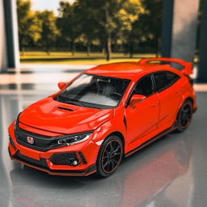 May include: A vibrant red model car with black wheels and trim. The car features a rear spoiler and a detailed front grille. The model is a Honda Civic Type R.