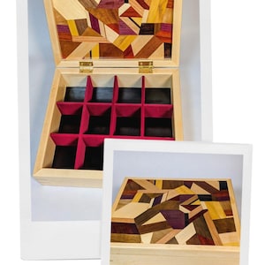 May include: Wooden jewelry box with a geometric mosaic design on the lid. The box is open, revealing a red velvet interior with nine compartments. The lid is adorned with various wood tones, including brown, yellow, and purple.