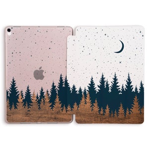 May include: A clear phone case with a design of a forest silhouette against a starry night sky. The case has a wood grain texture on the bottom half. The back of the case has a pink background with a white Apple logo.