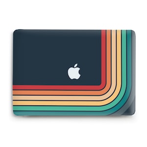 May include: A dark blue laptop case with a rainbow design on the right side. The rainbow is made up of red, orange, yellow, green, blue, and purple stripes. The Apple logo is in the center of the case.