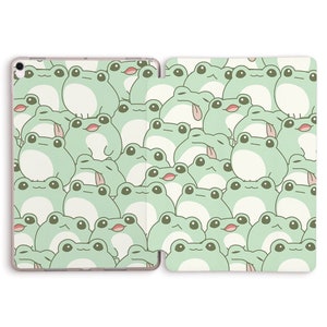 May include: A green iPad case with a pattern of cartoon frogs. The frogs are all different sizes and have big eyes.