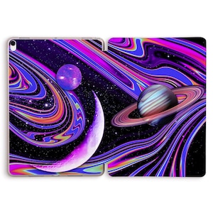 May include: A purple, pink and blue galaxy-themed iPad case featuring a crescent moon, a planet with rings, and a smaller planet. The case has a swirling, abstract design.