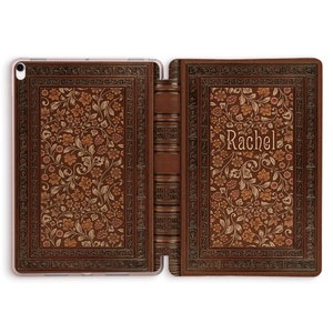 May include: A brown leather iPad case with a floral design and the name "Rachel" embossed on the front.