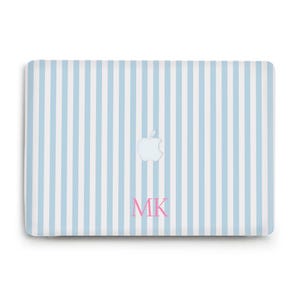 May include: A rectangular laptop skin featuring a vertical light blue and white striped pattern. The centre displays a white Apple logo cutout, and the lower section features the pink serif-style monogram letters MK printed in a clear font.