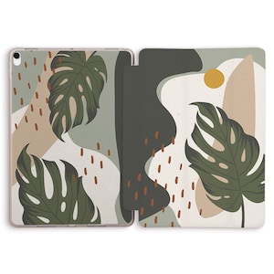 May include: A green, white, and brown iPad case with a tropical leaf design. The case has a stand feature and a flap that covers the screen.