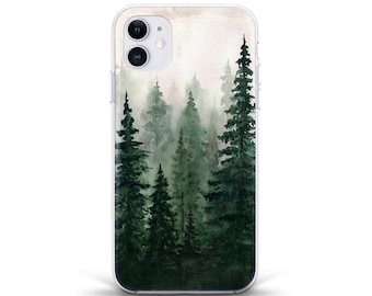 May include: A clear phone case with a watercolor design of a misty forest with tall green pine trees.