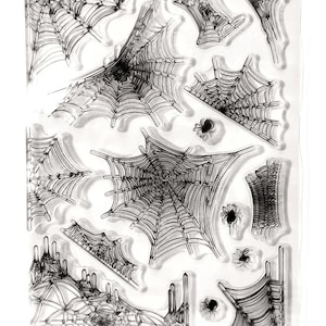 May include: Clear stamp set featuring various spider web designs and small spider illustrations. The stamps are in a variety of shapes and sizes, perfect for Halloween or spooky-themed crafts. The stamps are made of clear material.