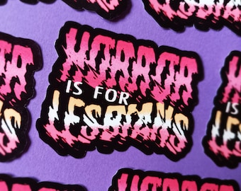 May include: A collection of stickers with the text "HORROR IS FOR LESBIANS" in a pink, white, and tan design. The stickers have a black border and are arranged on a purple background. The text has a distressed, layered effect.