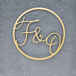 May include: A gold-colored wooden circle with the letters "F & O" in a cursive font.