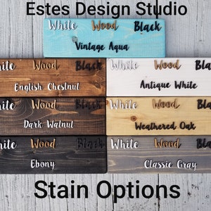May include: A wood stain color chart with the words "White", "Wood", and "Black" written on each sample. The stain colors include Vintage Aqua, English Chestnut, Antique White, Dark Walnut, Weathered Oak, Ebony, and Classic Gray.