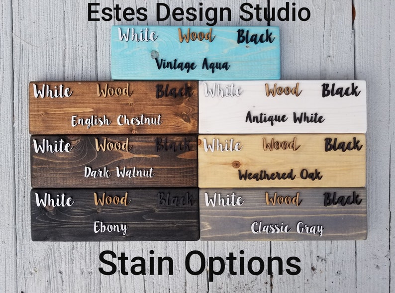 May include: A wood stain color chart with the words "White", "Wood", and "Black" written on each sample. The stain colors include Vintage Aqua, English Chestnut, Antique White, Dark Walnut, Weathered Oak, Ebony, and Classic Gray.