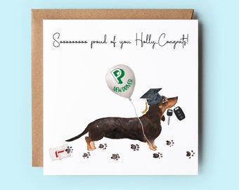 May include: A greeting card with a cartoon dachshund wearing a graduation cap and holding car keys. The dachshund is walking with a green balloon that says "New Driver". The card says "Soooooooo proud of you Holly Congrats!"