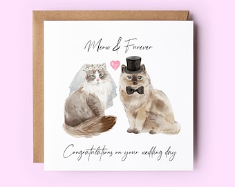 Può includere: Un biglietto di auguri per matrimonio con due gatti vestiti in abiti da matrimonio. La gatta indossa un velo bianco e una corona di fiori, mentre il gatto indossa un cappello a cilindro e un papillon. Il biglietto recita "Meow & Forever" e "Congratulazioni per il vostro matrimonio".