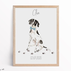 May include: A watercolour illustration of a black and white dog wearing a blue bow tie. The dog is sitting with its paws on the ground. The illustration is framed in a light wood frame. The text "Clive" is written above the dog and the date "02/07/2020" is written below the dog.