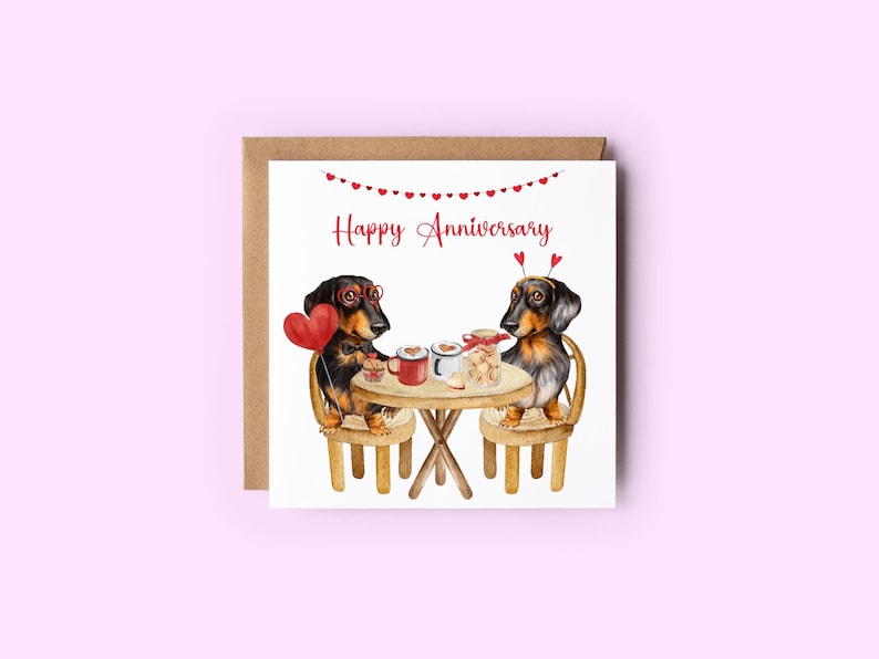 May include: A greeting card with a watercolor illustration of two dachshund dogs sitting at a table with a heart-shaped balloon, a cup of coffee, and a jar of cookies. The card reads "Happy Anniversary".