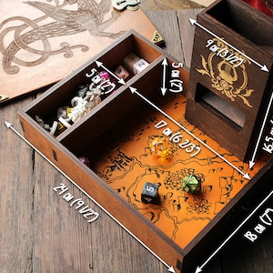 May include: A wooden box with a hinged lid, featuring a carved design of a mythical creature. The box has compartments for dice and a separate tower for rolling dice. The box measures 9 1/2 inches by 7 inches by 6 1/2 inches.