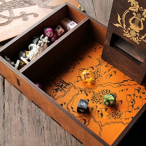 May include: A wooden box with a lid, a compartment for dice, and a dice tower. The box has a map design on the bottom and a compartment for dice. The dice tower has a dragon and lyre design.