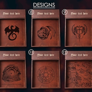 May include: Six different designs for a wooden tray with a leather insert. The designs include a dragon, a dragon with a crown, two dragons intertwined, a hobbit hole, a circle with a pentagram, and a map. Each tray has a space for text at the top.