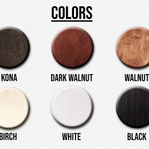 May include: Image displaying six circular wooden color samples: Kona, Dark Walnut, Walnut, Birch, White, and Black. The word "COLORS" is written in bold, black capital letters above the samples.