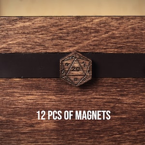May include: Wooden D20 dice magnets with a dark brown finish, displayed on a wooden surface. The magnets are engraved with numbers and geometric designs. The text "12 PCS OF MAGNETS" is displayed below the magnets.