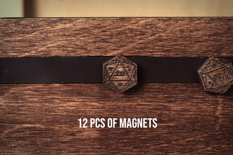 May include: Wooden D20 dice magnets with a dark brown finish, displayed on a wooden surface. The magnets are engraved with numbers and geometric designs. The text "12 PCS OF MAGNETS" is displayed below the magnets.