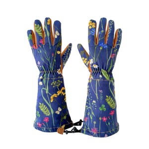 May include: A pair of blue gardening gloves with a floral print. The gloves have brown leather palms and a strap to connect the two gloves.