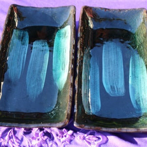 May include: Two rectangular ceramic serving dishes with a dark blue glaze and light blue brushstrokes.