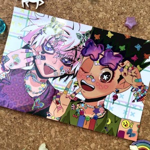 May include: A rectangular art print featuring two anime-style characters with vibrant hair, colorful accessories, and butterfly motifs. The character on the left has white hair and a purple shirt, while the character on the right has dark hair, purple star-shaped glasses, and a green shirt.