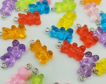 May include: Assortment of colorful gummy bear charms with silver jump rings. The charms are in various colors, including pink, purple, orange, yellow, green, and blue.