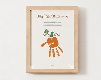 May include: A framed print titled My First Halloween featuring a poem and an orange handprint shaped like a pumpkin with a green stem and leaves. The text reads My First Halloween, My little hand, so tiny and sweet, Made a pumpkin that's such a treat! My first Halloween is here to stay, A precious memory from this special day. The year 2026 is printed at the bottom.